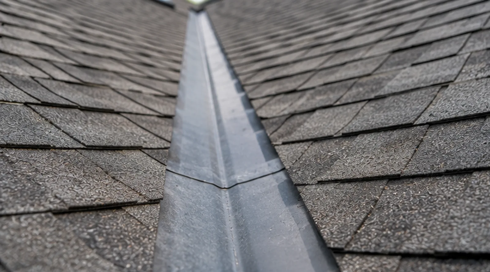 Roof flashing and shingles examined during a St. Paul roof inspection